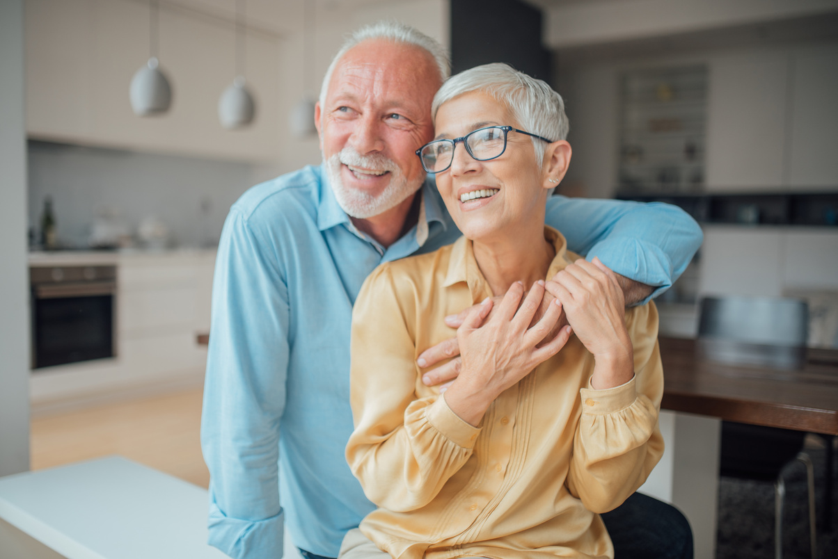 Smiling old couple hugging